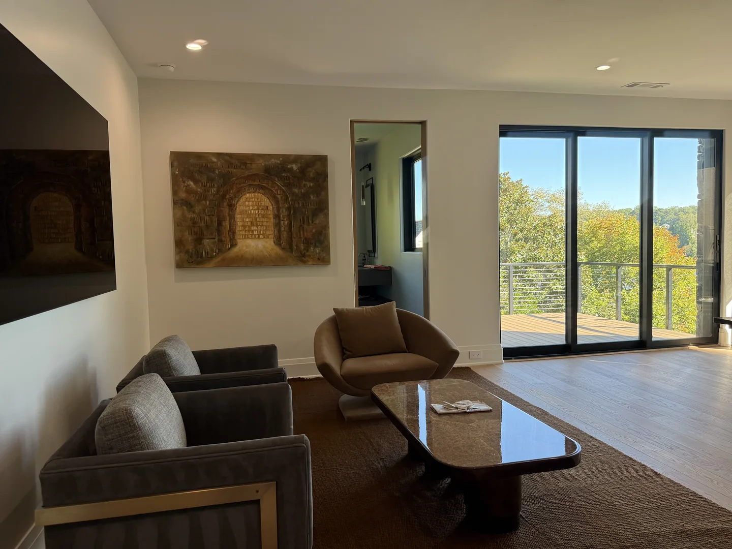 Lakeside salon with lounge seating and terrace view