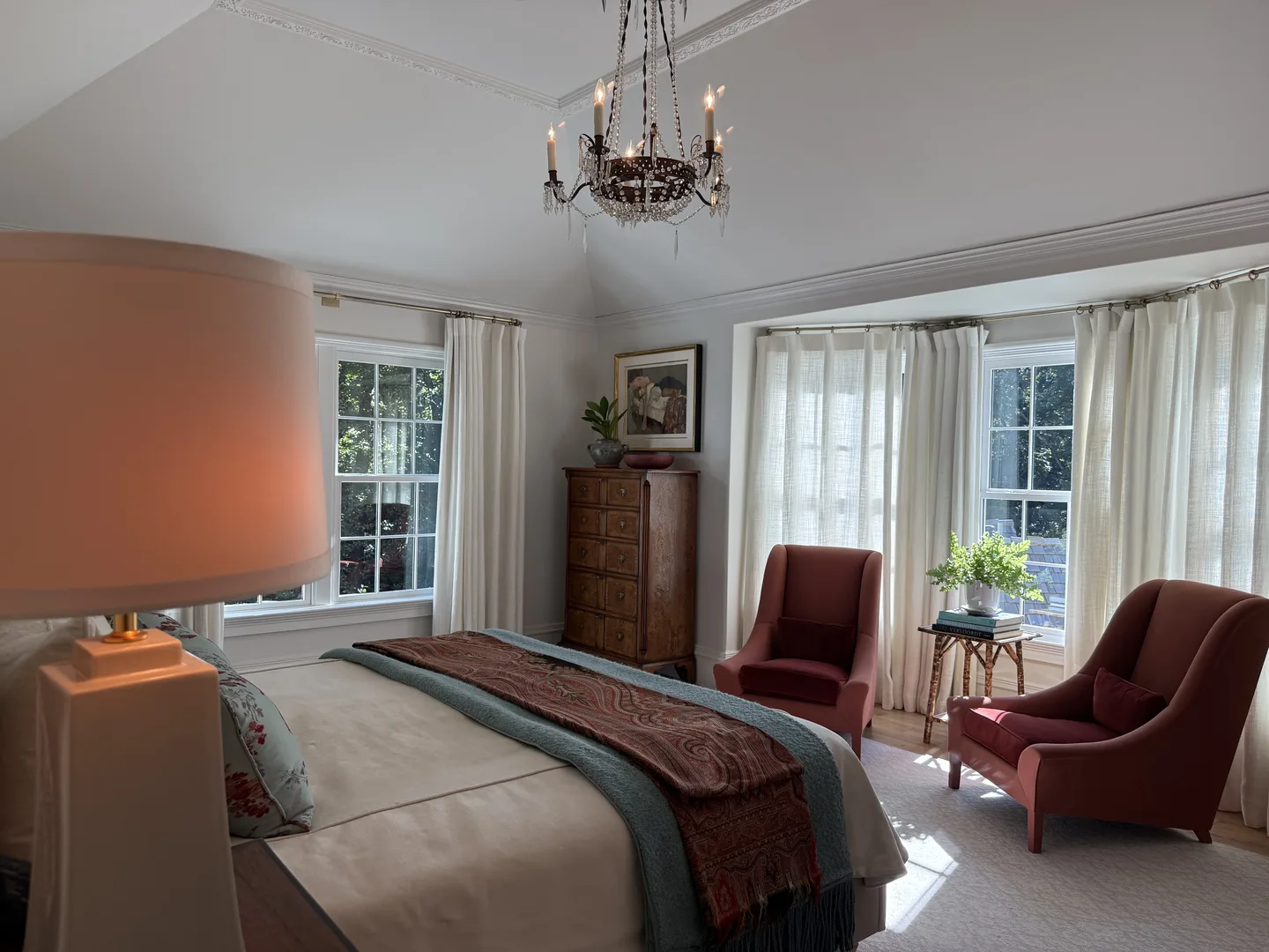 Vaulted primary suite with crystal chandelier and reading lounge