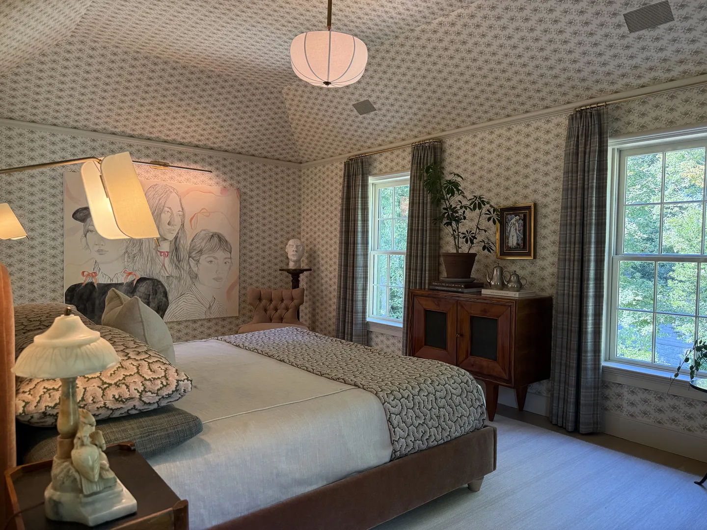 Guest bedroom with tailored wallcovering and curated credenza