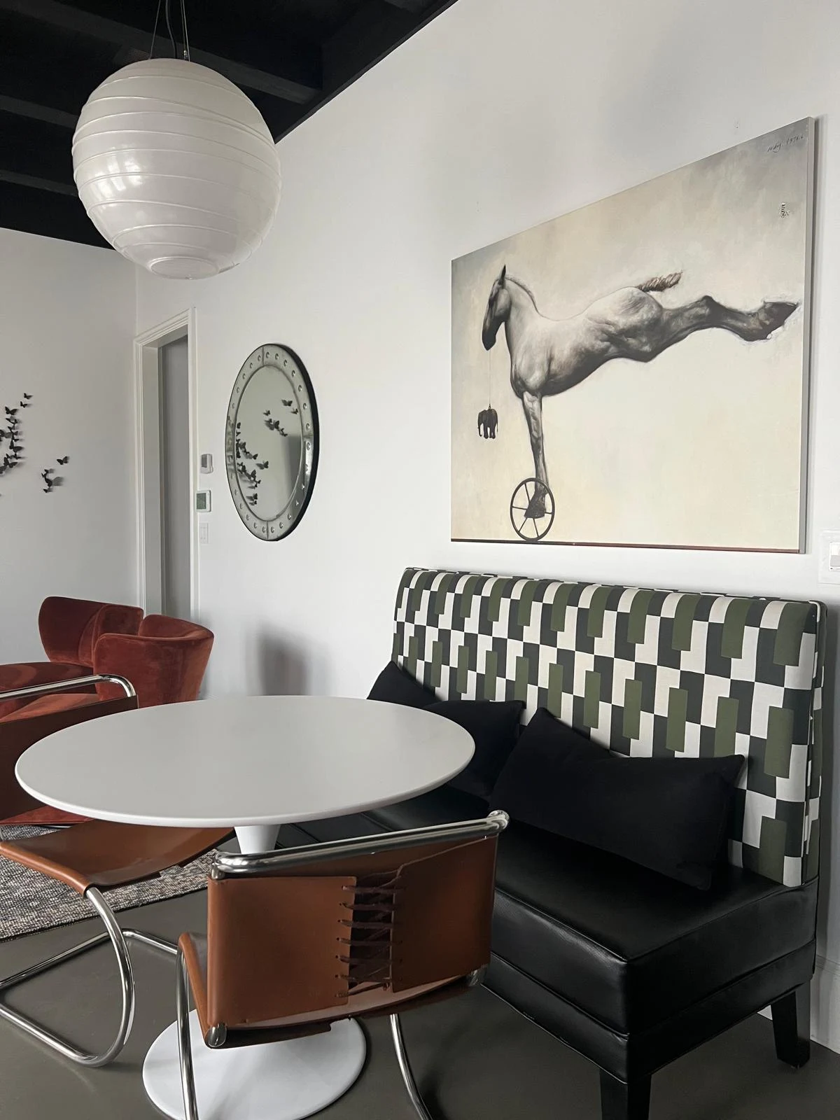 Fine curated interior breakfast alcove with architectural art in private estate