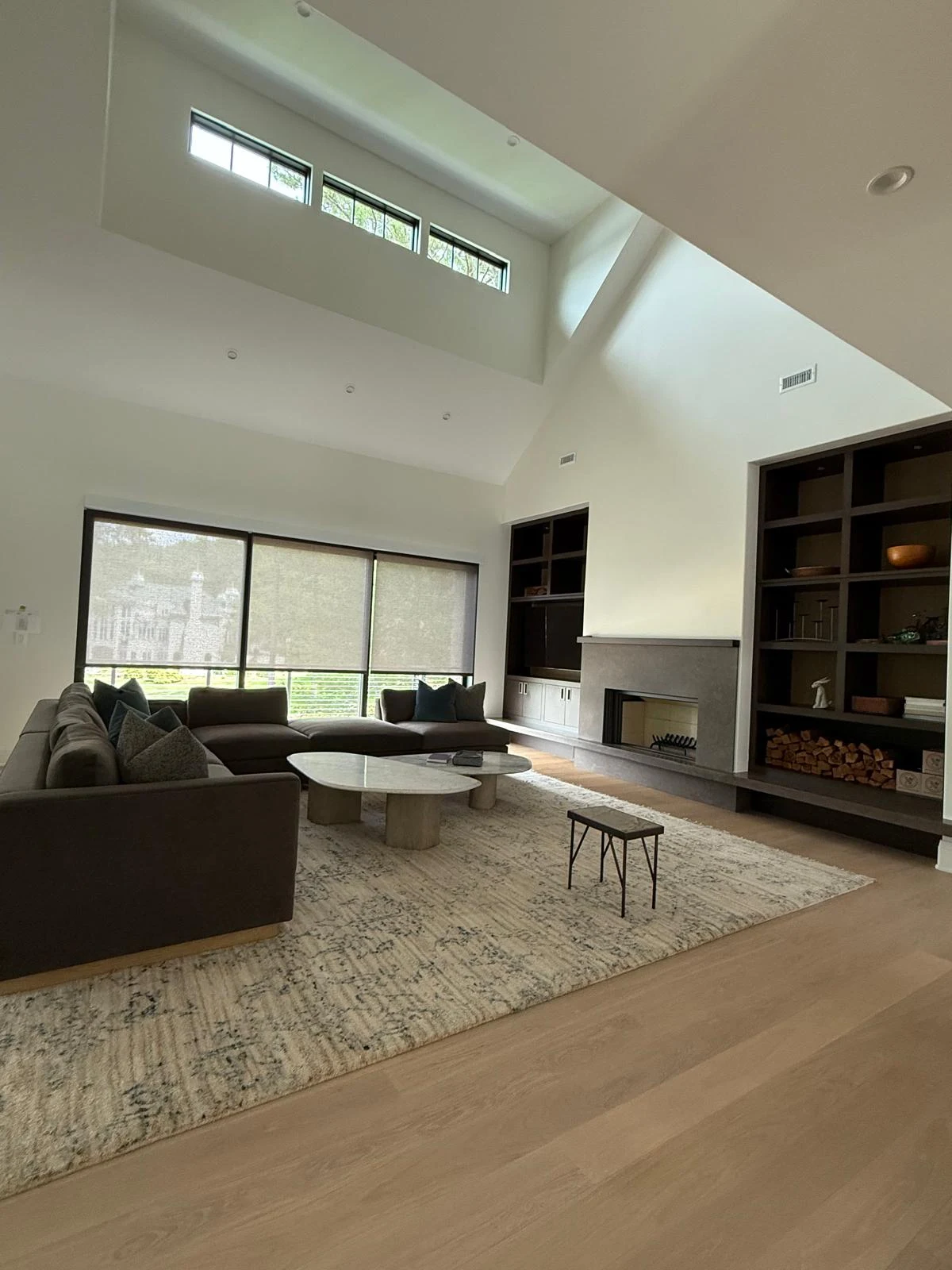 Double-height cathedral window living room prepared after construction completion